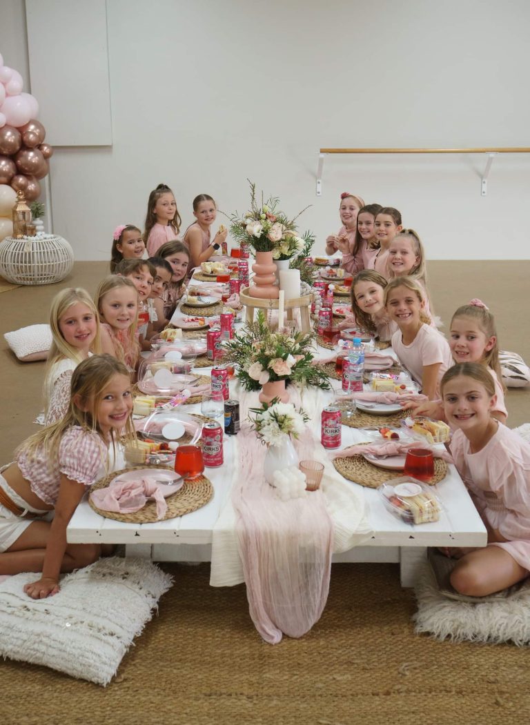 Group of kids at a picnic table enjoying each other's company during a party at The League Studios in Hervey Bay